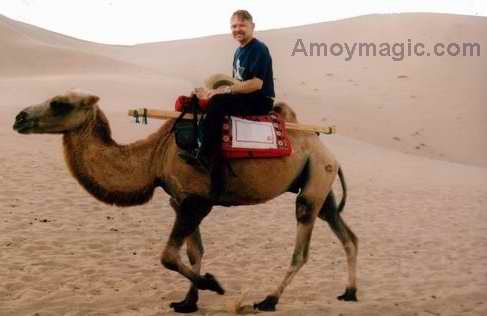 Bill rides a camel near Dunhuang in a West China desert