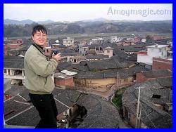 Babushka on a rooftop taking photos of a walled Hakka village in Tufang, Changting (in Longyan, West Fujian)