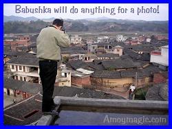 Babushka on a rooftop taking photos of a walled Hakka village in Tufang, Changting (in Longyan, West Fujian)