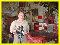Len McClure filming inside a  small shrine for a local god