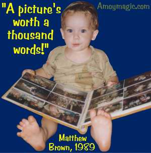 Photograph of Matthew Brown , in Xiamen, two years old, looking at photographs