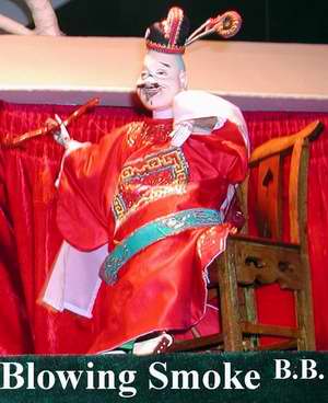 A Zhangzhou hand puppet smoking a pipe.  These amazing little people perform acrobatic feats, like spinning plates, juggling--or even tossing each other into the air.  Incredible.