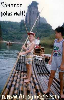 Shannon poles a bamboo raft